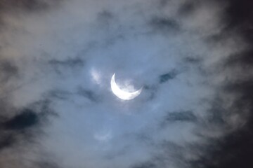 Naklejka na ściany i meble Solar eclipse through clouds