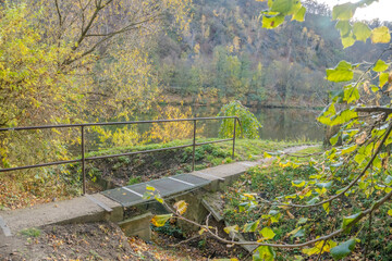 Small wooden iron pedestrian bridge to the river Berunka in Hlasna Treban, czech