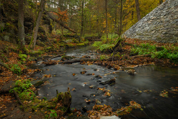 Doubrava river with color rock with moss in autumn day near Bilek village