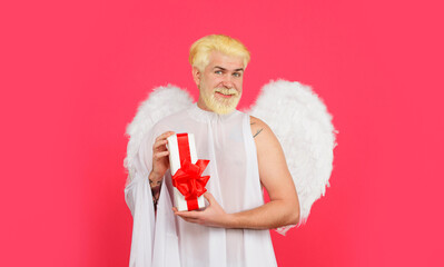 Happy Valentines Day. February 14. Valentines day angel in white wings with Valentine present....