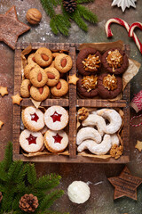 Box with variety of Christmas cookies: linzer cookies with strawberry jam, crescents with walnuts...