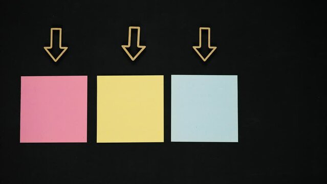 Four arrows pointing on blank color sheets. Background for caption. Stop motion
