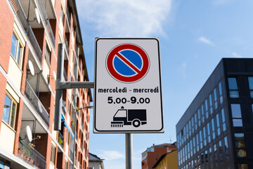 Bilingual traffic sign in the Aosta Valley, Italy with information that the street sweeper runs...