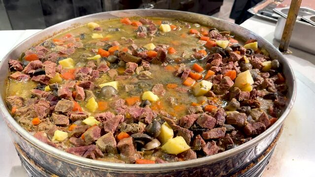 Turkish Tas Kebab or Roasted Meat Kavurma in pan, traditional delicious Turkish food potato and meat dish.