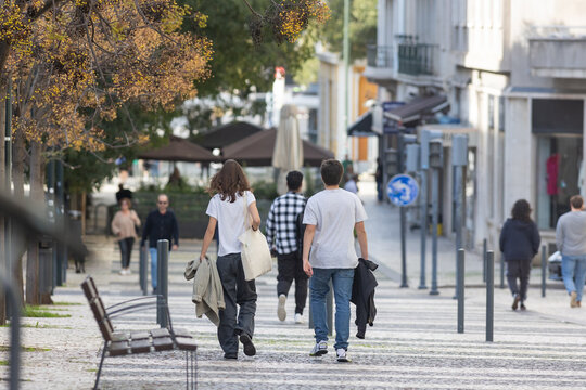 A Couple - Man And Woman Walking Down A Street