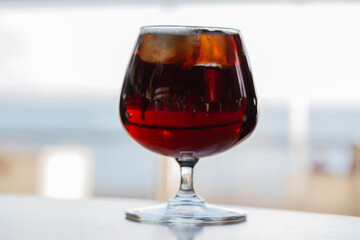 glass of cognac on a wooden table in the bar