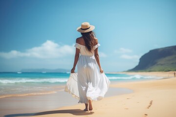 Fototapeta na wymiar Lovely graceful lady in long skirt walk on sand beach with beautiful seascape. Summer tropical vacation concept.