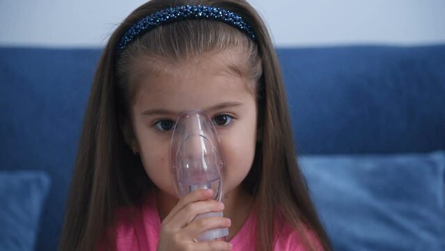 Portrait of a child in an inhalation mask. Children's lung health concept. Close up