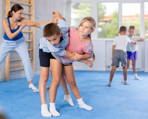 Young jiu jitsu students are fine-tuning their striking techniques in dojo.