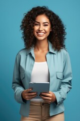 Fototapeta premium Gen Z leader brainstorming over digital tablet energizing blue background with empty space for text 