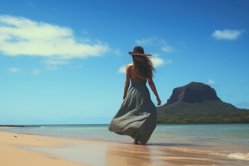Lovely graceful lady in long skirt walk on sand beach with beautiful seascape. Summer tropical vacation concept. - obrazy, fototapety, plakaty