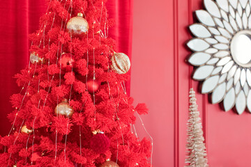 Red Christmas tree with golden decorations