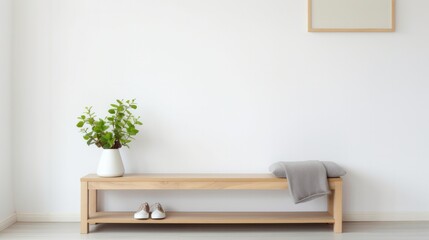 The bench and plant placed in front of a white wall create a calm and minimalist indoor environment.