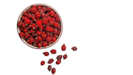 Dried rose hips in a bowl, isolated on a white background.