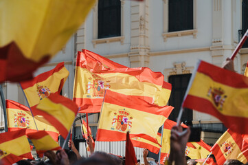 Hundreds of people demonstrating with flags of Spain