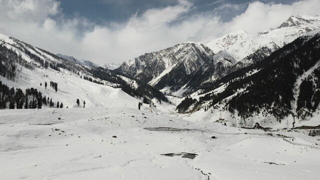 Aerial view of Sonamarg in Kashmir, India with forests and hills covered by snow