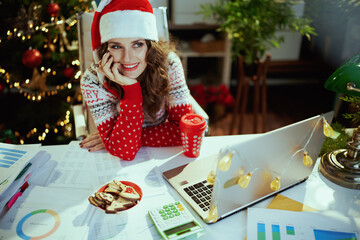 business owner woman in green office with Christmas tree