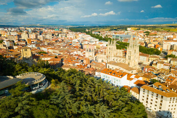 Fototapeta na wymiar View from drone of impressive Burgos Gothic Cathedral on background of cityscape in summer day, Spain