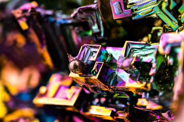 bismuth hopper crystal macro detail texture background. close-up raw rough unpolished semi-precious...