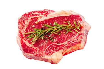 Raw beef steak with sprig of rosemary and peppers isolated on white background.