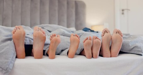 Sleeping, feet and family in a bed relax, dreaming or bond in vacation freedom at home. Barefoot, love and children with parents in a bedroom wake up from sleep, nap or resting, calm and peaceful