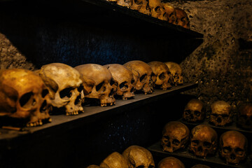 Human skulls in old crypt or catacombs