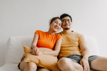 Lovely romantic asian couple watching tv movie together happy vibes weekends