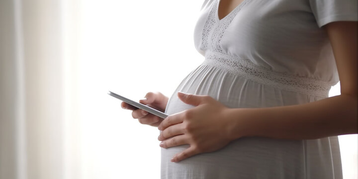 Pregnant woman checking cell phone