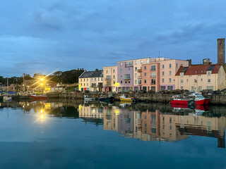 St Andrews, Scotland - September 22, 2023: Views of the buildings, vessels, breakwater and marina in St Andrews Scotland at sunrise
