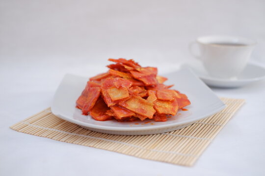 Keripik singkong balado or balado cassava chips on a serving plate, it tastes spicy, sweet and crunchy