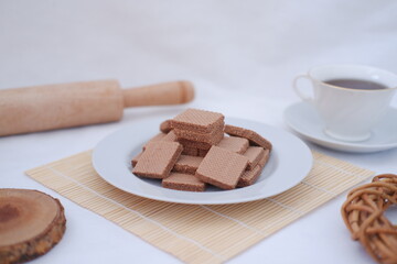 photo delicious wafers and a cup of coffee for breakfast, top view