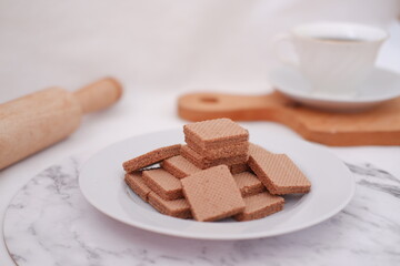 photo delicious wafers and a cup of coffee for breakfast, top view