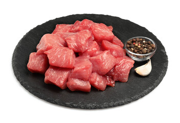 Pieces of raw beef, garlic and peppercorns isolated on white