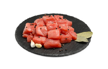 Pieces of raw beef, garlic, bay leaves and peppercorns isolated on white