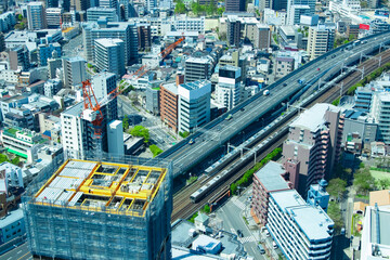 A crane at the top of the building near the city highway in Osaka