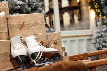 Many gift boxes, skates and festive decor indoors. Interior design