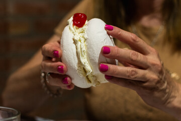 photograph of meringue with cream and dulce de leche and the dessert cherry