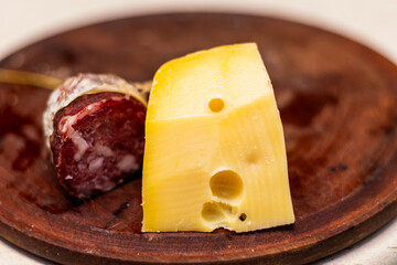 cheese on a plate and salame 