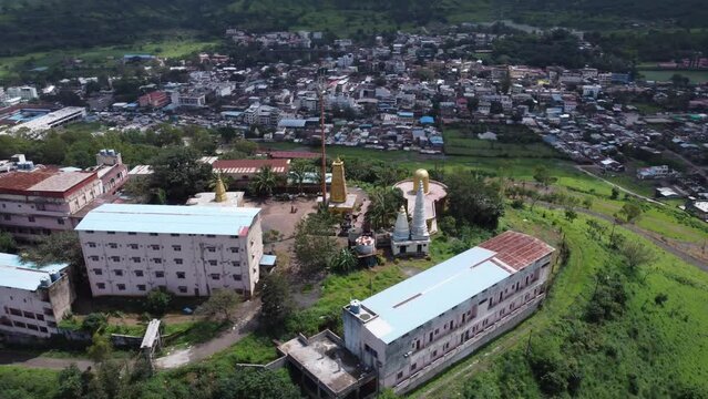Aerial view of Nil Parvat sacred temple on the edges of Brahmagiri hills with the view of Trimbakeshwar town in the background, Nashik, Maharashtra, India