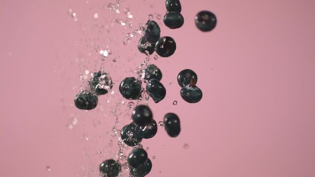 Water Is Being Splashed Along With Blueberries