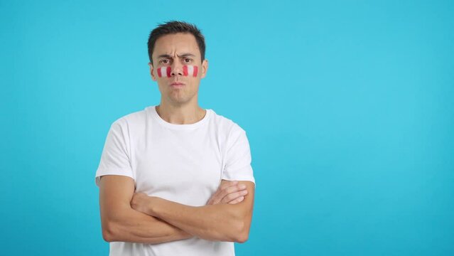 Dignified and serious man with peruvian flag painted on face