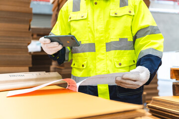 paper cardboard manufacture factory concept, industry worker person working with machine to recycling material package box in warehouse storage or plant production for global logistic business