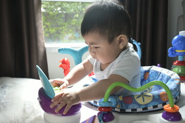 A baby boy is playing toys