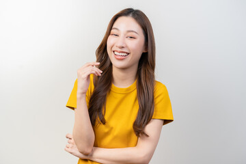 Smile positive, attractive asian young woman wearing yellow casual, portrait of beautiful brunette her with long hair, cute girl feeling happy, standing cross arms chest isolated on white background.