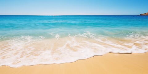 Fototapeta na wymiar a beach with blue water and blue sky