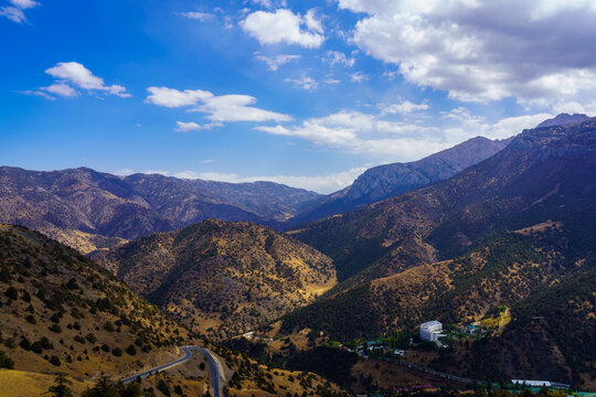 Mountains covered with grass and trees and cloudy dramatic sky on a daytime in Zaamin reserve.