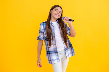 young karaoke singer girl smile hold microphone. teen girl singer hold mic in studio. young girl...