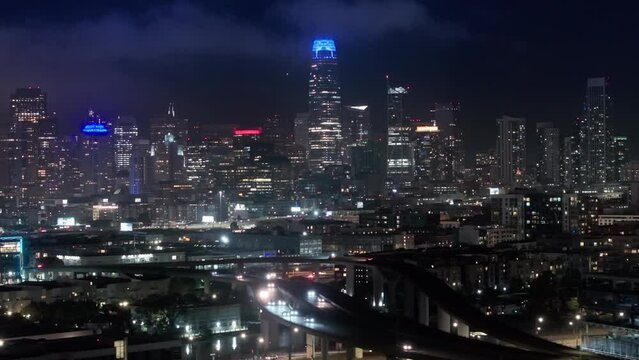 Cinematic panorama of night San Francisco downtown at night illumination. Scenic views of modern contemporary city with night illumination. Aerial views of traffic multi levered highway California USA