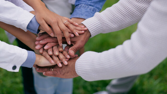 People, hands stack and circle in park for support, teamwork or solidarity with goals in nature. Group, huddle and outdoor for family trust, link and connection with synergy with motivation on lawn