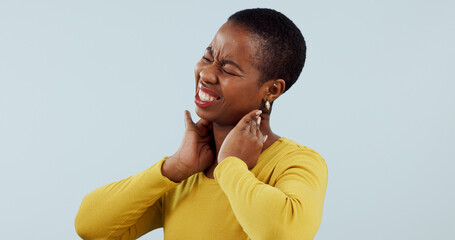 Black woman, neck pain and injury in stress, pressure or anxiety against a gray studio background....
